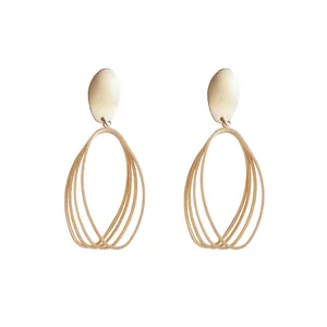 Minimalist geometric hollow matte gold earrings featuring a multi-layered oval design