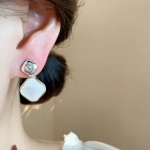 Detailed close-up showing 18k gold plated zircon diamond clip-on earrings on ear