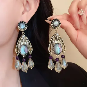 Detailed view of vintage court-style dangle earrings with pearls and crystal beads.