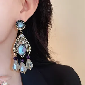 Detailed macro shot of vintage court style dangling earring with blue-grey stones and pearls