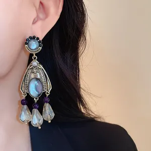 Detail of vintage court style drop earrings with iridescent stones and crystal teardrops