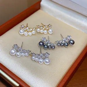 Three pairs of elegant 18k gold plated pearl and zirconia stud earrings in a box