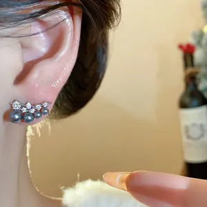 Close-up detail of silver ear climber with grey pearls and cubic zirconia stones