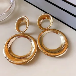 Chunky gold-toned metal hollow double hoop earrings with radiant texture design