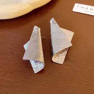Stylish irregular geometric metal stud earrings featuring striped and hammered textures