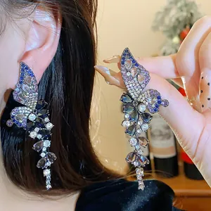 Sparkling zircon butterfly wing earrings with cascading blue and purple gems detail.