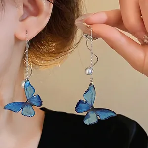 Elegant blue butterfly wing dangle earrings with pearls and silver needles for women