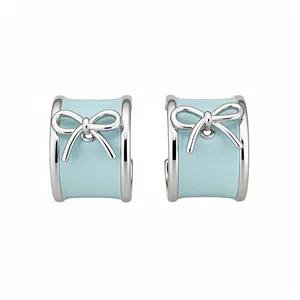 Elegant silver-tone C-shaped stud earrings featuring light blue enamel and bow design