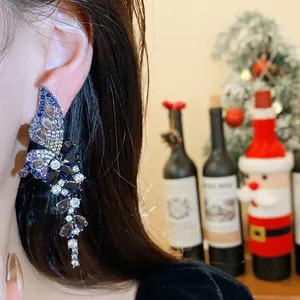 Retro zircon butterfly wing earring with sparkling crystals shown in a detail shot on model.