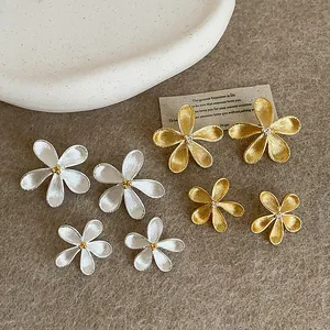 Elegant gold and silver flower stud earrings in large and small sizes with textured finish