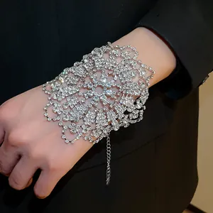 Detailed close-up of an intricate rhinestone flower lace cuff bracelet worn on the wrist