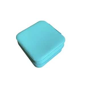 Portable square turquoise faux leather jewelry organizer box with secure zipper closure