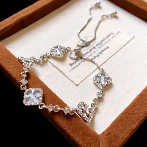 Elegant silver adjustable clover bracelet with white mother-of-pearl and sparkling crystals