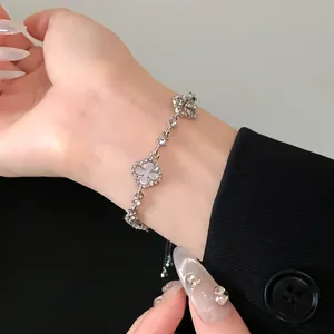 Close-up of elegant hollow flower charm bracelet with rhinestones and adjustable cord