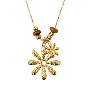 Elegant gold-tone necklace with tiger eye beads and floral pendant design