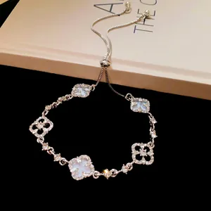 Detailed view of silver adjustable bracelet with sparkling hollow flower charms.
