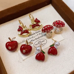 Elegant red enamel and zircon stud earrings set with apple and rocking horse designs