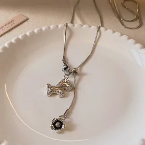 Detailed macro shot of elegant zircon silver horse pendant necklace with flower charm