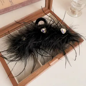Elegant black feather hair claw clip with sparkling heart rhinestones for autumn winter