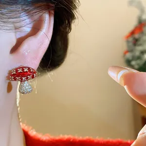 Close-up detail of a red mushroom stud earring encrusted with sparkling cubic zirconia.