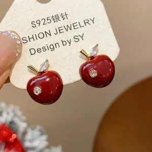 Close-up detail of red enamel apple earrings with zircon on S925 silver needle card