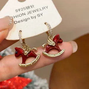 Close-up of red enamel rocking horse earrings with S925 silver needles and zirconia hoops.