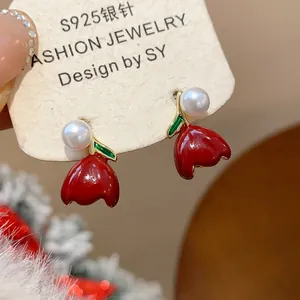 Close-up detail of red tulip earrings with white pearls and S925 silver needles