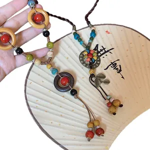 New Chinese style necklace featuring ceramic beads, wooden rings and tassel details