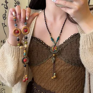Detail view of a vintage New Chinese style necklace with ceramic beads and wood rings