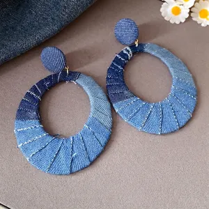 Large vintage style oval denim fabric hoop earrings with white stitching details