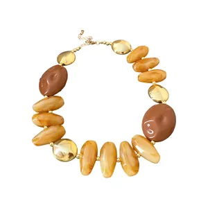 Chic vintage Maillard style necklace featuring irregular amber beads and gold-tone metallic discs