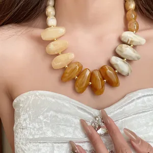 Close-up detail of Maillard retro irregular teardrop necklace worn by a female model
