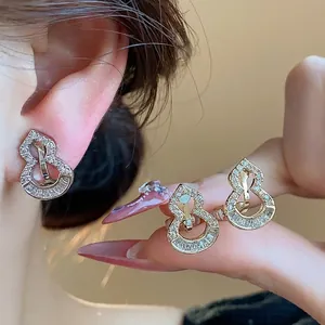 Elegant 18k gold plated gourd-shaped clip-on earrings with shimmering zircon stones