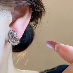 Macro view of elegant 18k gold plated zircon gourd ear clip worn on a female ear