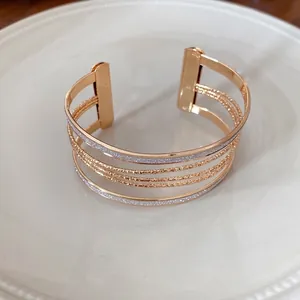 Elegant gold multi-layer open cuff bracelet with silver glitter accents for women