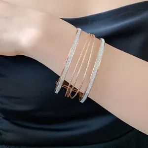 Elegant multi-layer gold-toned bangle set with glitter finish for women