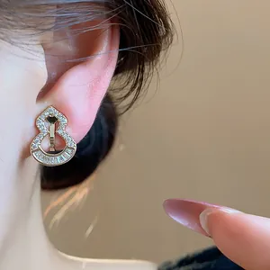 Close-up detail of 18k gold plated hulu gourd ear clip with sparkling zirconia stones