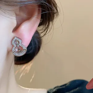 Close-up of 18k gold plated zircon gourd ear clip for non-pierced ears