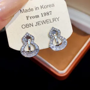 Close-up of sparkling zircon gourd-shaped clip-on earrings with 18k gold plating.
