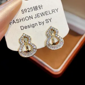 Detail view of 18k gold plated gourd clip earrings with sparkling zircons for women.