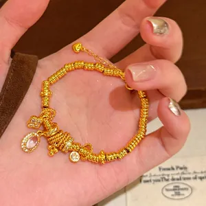 Detailed view of a gold plated zircon flower bracelet with elegant charms and beads.