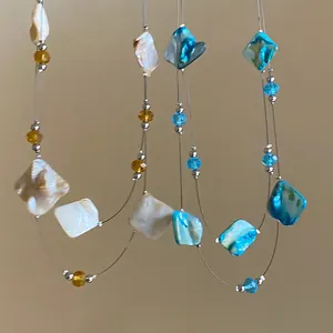 Bohemian natural shell and glass beaded double-layer necklace for summer vacation style.