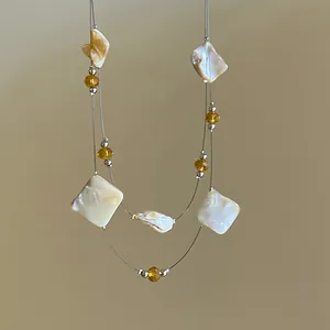Double-layer necklace with irregular shell squares and yellow glass beads for summer.