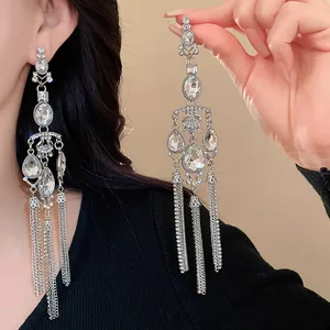 Detailed shot of long silver tassel earrings featuring sparkling teardrop rhinestones