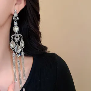 Detailed shot of sparkling silver crystal water-drop tassel chandelier earrings