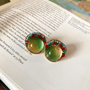 Vintage French palace style round resin beaded earrings featuring an elegant gold finish