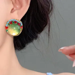 Elegant French style vintage resin beaded round stud earring featuring a warm green glow