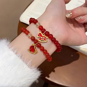 Red agate rutilated quartz beaded bracelet with gold rocking horse charm