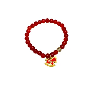 Handmade red agate beaded bracelet with gold rutilated quartz and rocking horse charm