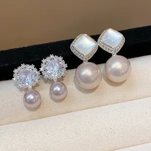 Macro detail of zircon flower and mother-of-pearl stud earrings with purple pearls